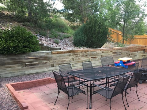 Backyard bluff with patio set
