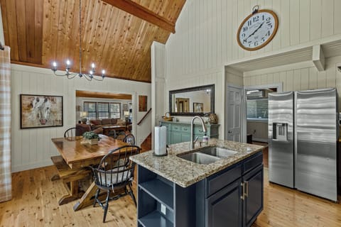 The kitchen has an island and large dining table for the entire family