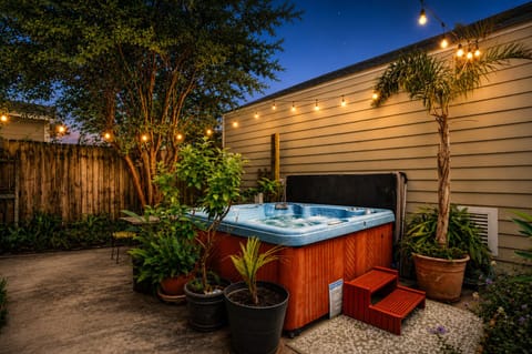Relax under the stars in our private New Orleans courtyard garden, surrounded by lush tropical greenery and the warm glow of string lights. The spacious 8-person hot tub is the perfect place to unwind after a day exploring the city.