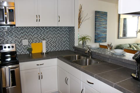 Brand new appliances, cabinets and counter tops