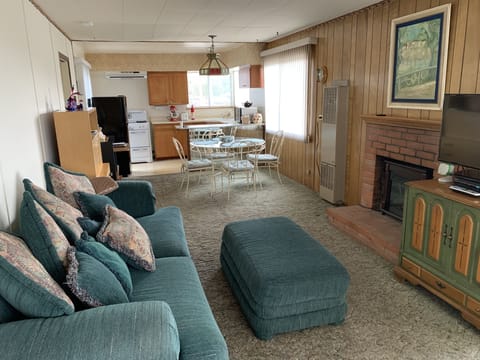 Living room toward dining area (Grandma's round table), more windows!