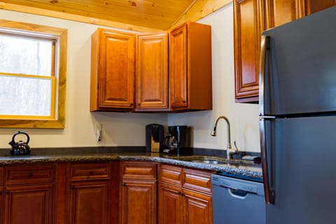 Fully equipped kitchen with ample storage and counter space, coffee maker
