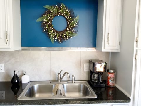 Side by side refrigerator, self cleaning oven, and a stainless steel sink