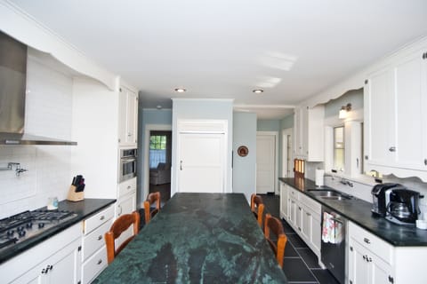 Large chef's kitchen with Kitchen Aid stove, fridge, dishwasher and microwave.