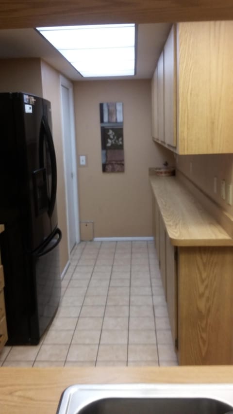 Fully equipped kitchen with entrance to the laundry area.