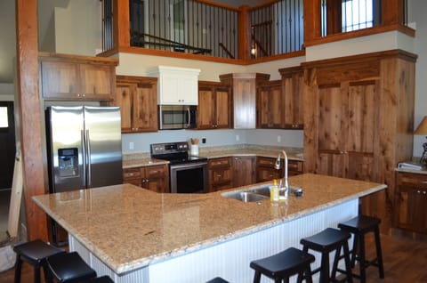 Kitchen is fully stocked with dishes, utensils, pans, etc.