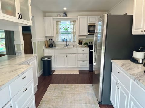Fully stocked kitchen including crockpot and grilling utensils.