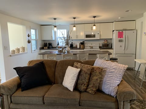 Cozy Living room open to kitchen with couch, recliner, DirecTV and internet. 