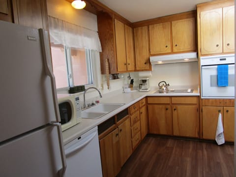 Microwave, refrigerator/freezer, dishwasher, coffee maker and cooking gear.
