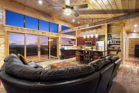 Wake up to nature’s masterpiece – Cozy living meets breathtaking mountain and forest views, all from the comfort of The Summit House’s open and inviting great room.