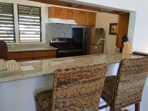 Another view of kitchen with barstools