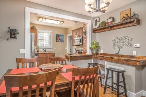 Our dining room has bar height seating for 4 and a handcrafted bar with stools. 