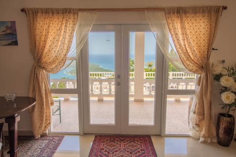 view of the harbor through the french doors of the living room