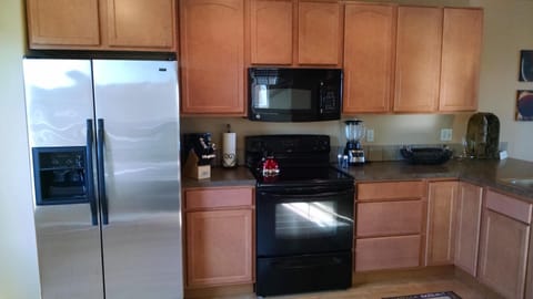Kitchen with newer appliances, mountain and water view.