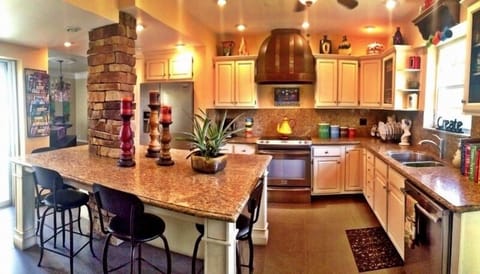 Fully stocked kitchen. Large island with bar stools.