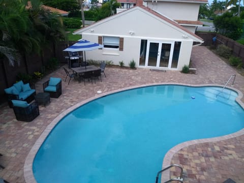 Large Pool  Sofa Two Chairs Dining Table Weber Grill, Main House In Background
