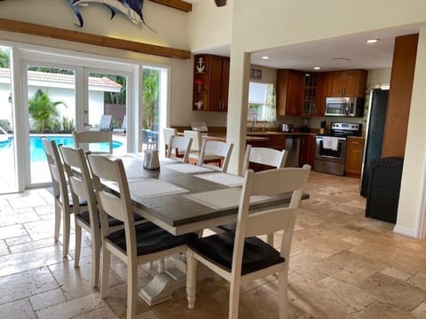 Main house  11 foot dining table seats 8 comfortably overlooking the pool deck