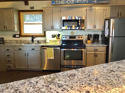 Well equipped kitchen with two sinks and 4 additional seats at the bar