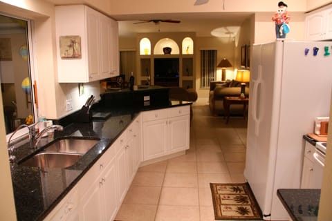 Well equipped kitchen with granite counters and pass-through to the pool.