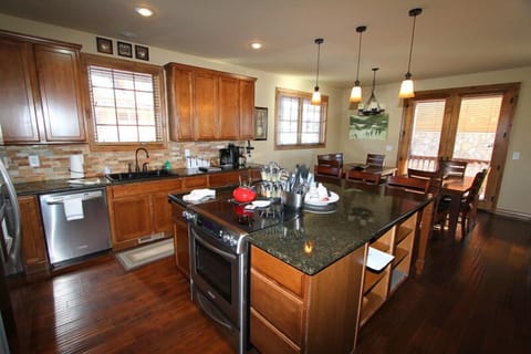 Gourmet kitchen with granite counter tops, stone accents, stainless appliances and breakfast bar