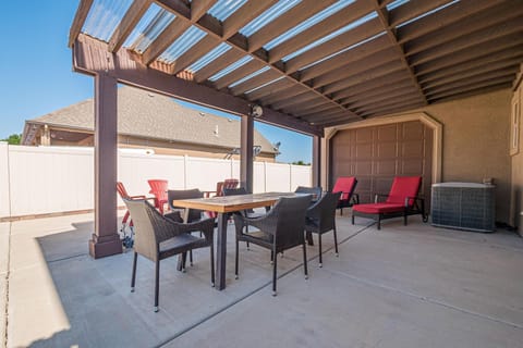 Shaded patio with cozy seating and dining area for relaxing outdoors