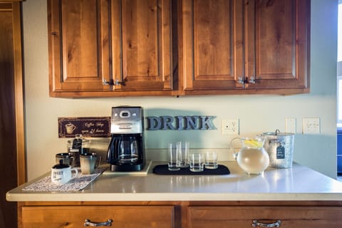 Beverage station.  Coffee pot, mugs and bare ware