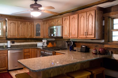The kitchen has granite counter tops.  It has 4 bar stools and a 6 burner stove