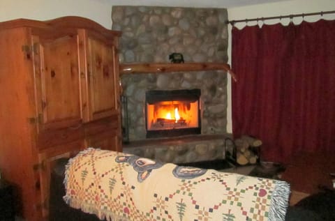 River rock wood burning fireplace.