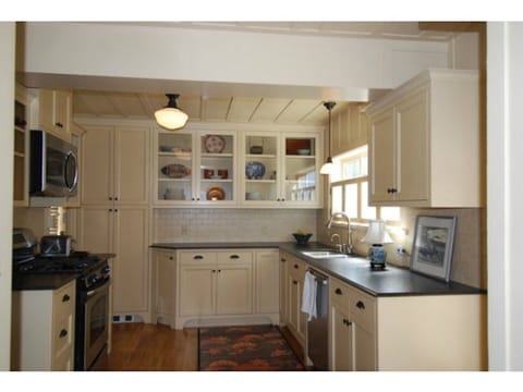 kitchen has stove, microwave, dish washer, and laundry room has washer and dryer