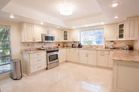 Spacious upgraded kitchen with granite countertops and stainless steel