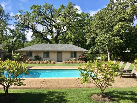 The cottage is in a landscaped pool courtyard across from the main house