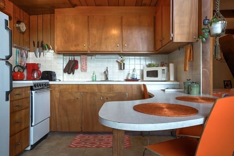 Kitchen with fridge, stove/oven, microwave, coffee maker, teapot, toaster