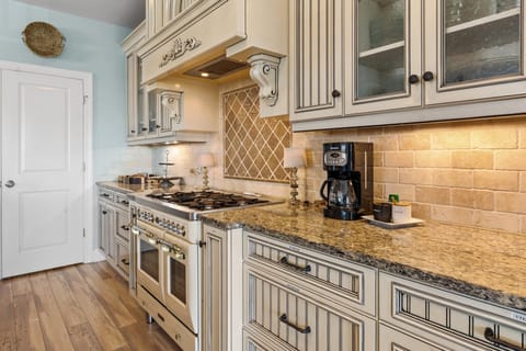 Gas stove with small oven for baking and a tiny side oven for reheating.