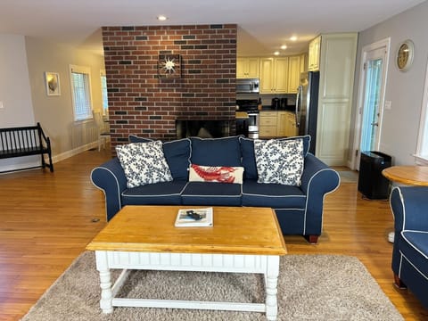 Living room looking into the kitchen and toward fireplace