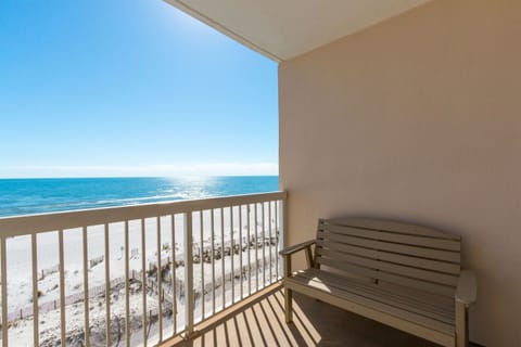 Balcony has a a bench and 2 chairs.