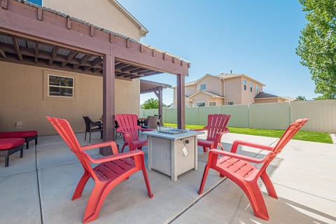 Sunny patio retreat with cozy fire pit and vibrant seating