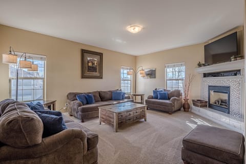 Cozy living room with fireplace and ample natural light