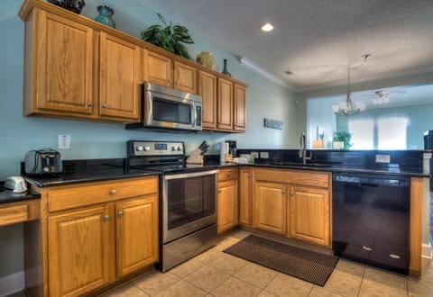 Large kitchen for family meals with granite counters and full size fridge 