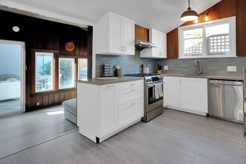 Kitchen connected to Sunroom with view of Backyard