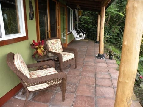 Charming lanai overlooks the lush garden and ocean