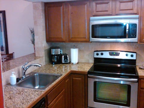 Fully equipped kitchen with stainless steel appliances. 