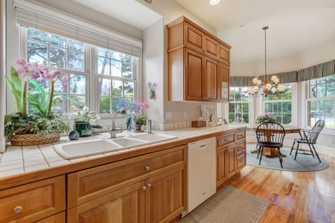 Charming kitchen sink area with a picturesque view and beautiful floral accents.