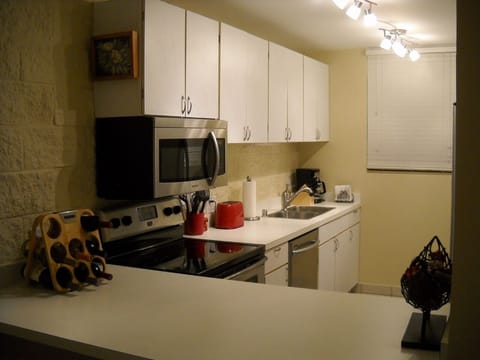 The fully furnished kitchen with all new stainless appliances
