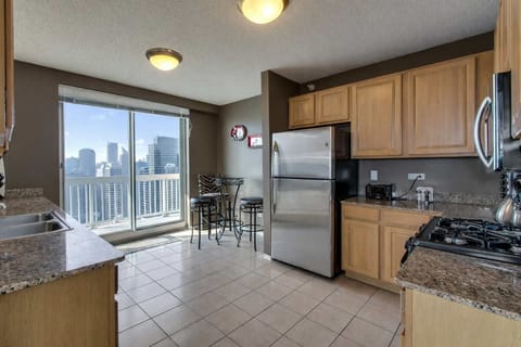 Fully equipped kitchen with balcony access.
