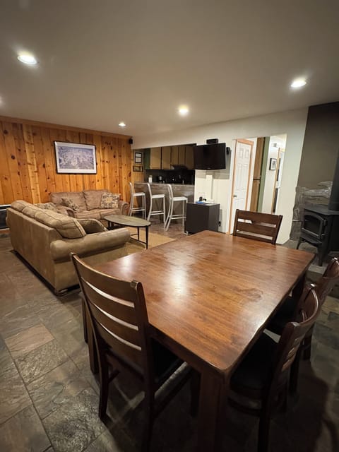 Family room with kitchen table, tv, fireplace, bar, pull out couch & loveseat