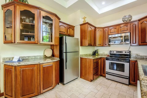 Mahogany and granite highlight the fully-equipped kitchen!