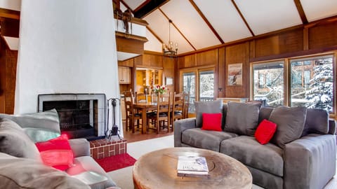 Living room and dining room wrap around the warm and cozy fireplace.