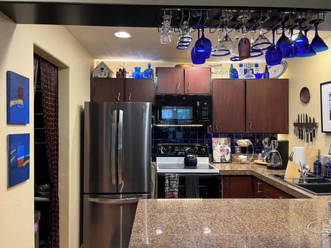 New fridge, under cabinet lighting, and cobalt blue tile backsplash