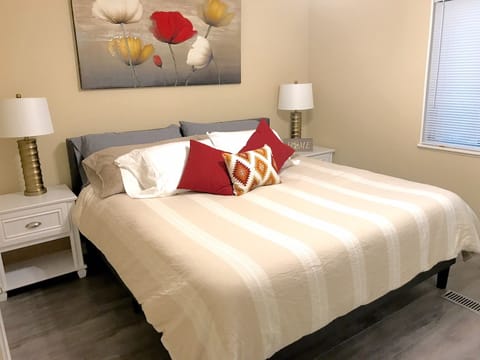 King size bedroom, large front window, ceiling fan; walk in closet