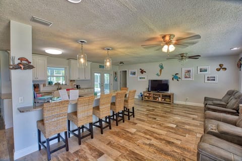 From front door you have a large island with seats/kitchen and living room area.